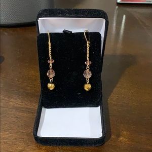 Gold and pink dangle earrings.